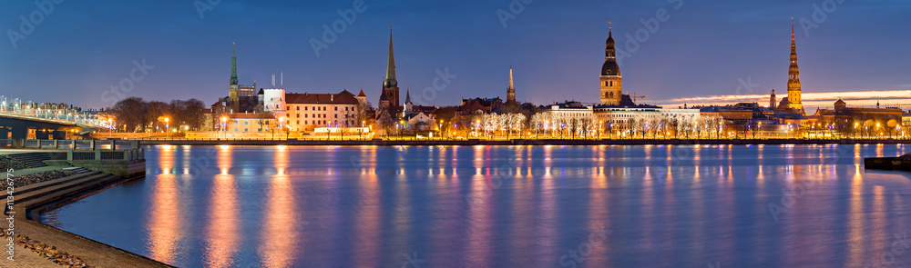 Nocturnal panoramic view on medieval city of Riga from embankment of the Daugava river. Riga is the capital of Latvia and famous Baltic city of medieval architecture