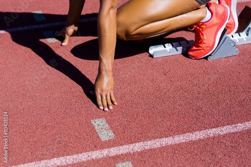 Female athlete ready to run on running track