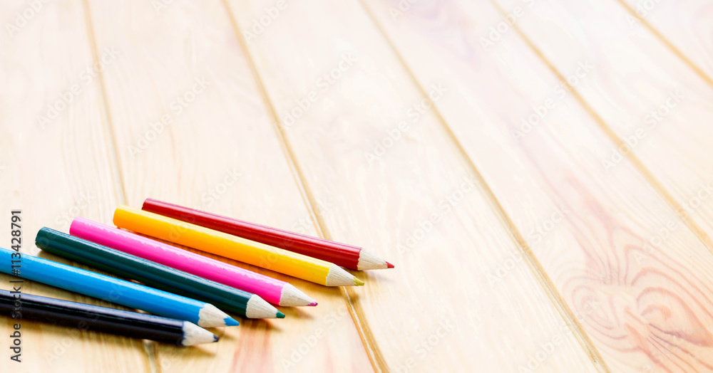 Fototapeta premium color pencils on brown wooden table