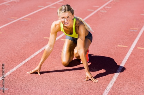 Female athlete ready to run on running track © WavebreakmediaMicro
