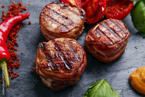 Grilled meat fillet steak wrapped in bacon medallions