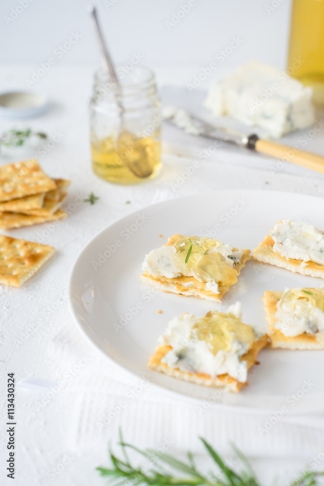 Crackers with gorgonzola and herb and white sweet wine  jelly. Selective focus
