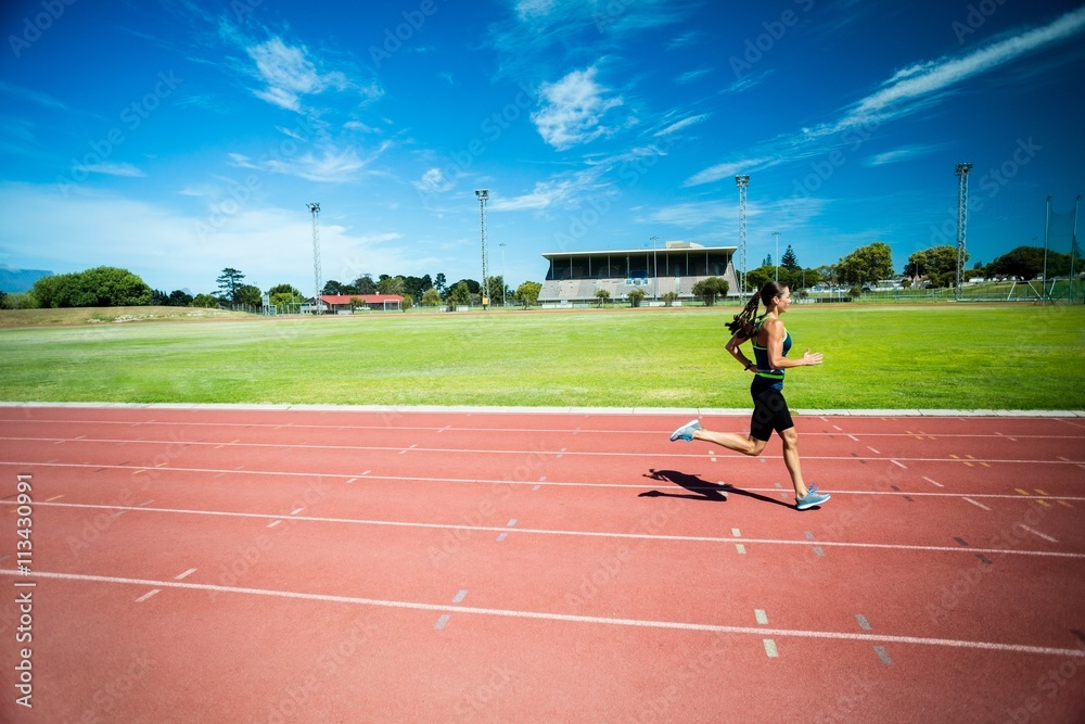 Female athlete running on the running track Female athlete running on the running track