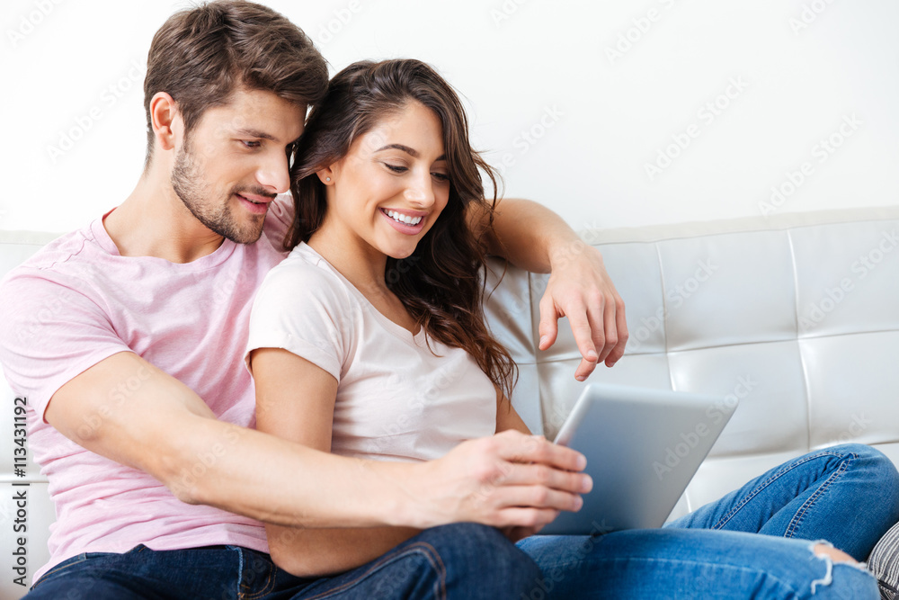 Smiling couple using pc tablet over white background Smiling couple using pc tablet over white background