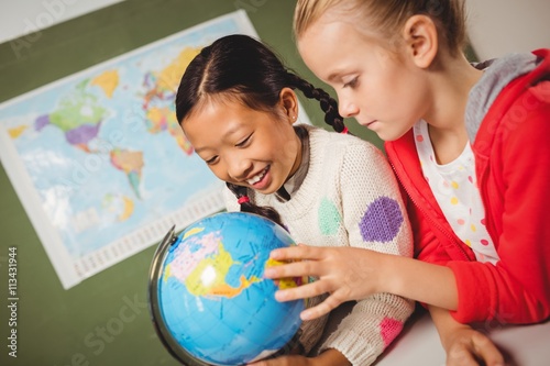 Girls studying the globe