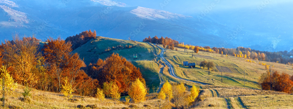 Rural road on autumn mountain slope.