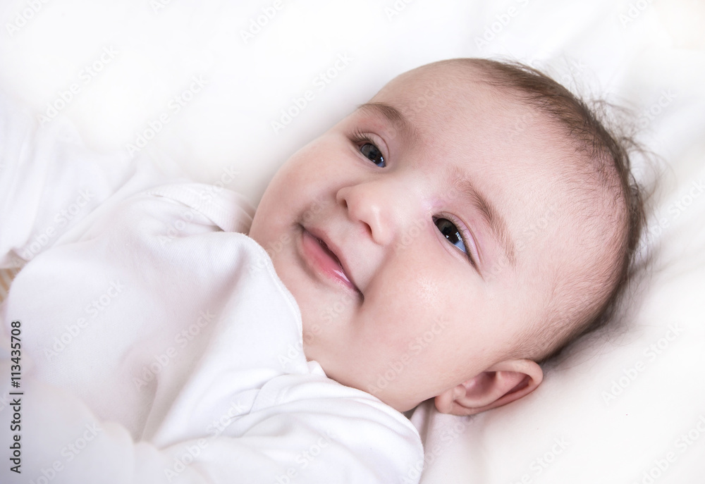 Child playing in a bed and does not want to sleep Child playing in a bed and does not want to sleep