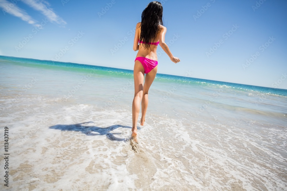Attractive woman running on beach
