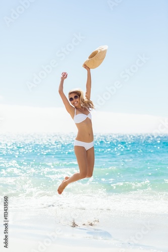 Young woman jumping on beach