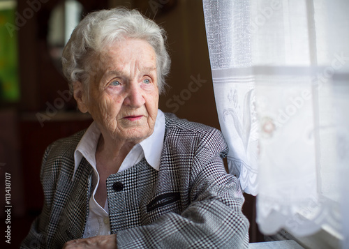 Portrait of an elderly woman in a formal suit.