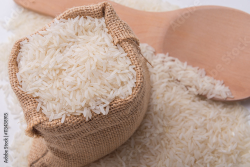 Rice background with wooden spoon.