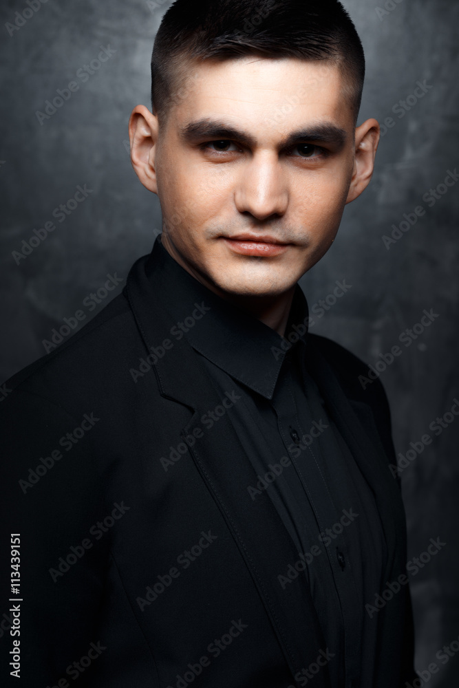 Portrait of handsome man in a black suit.