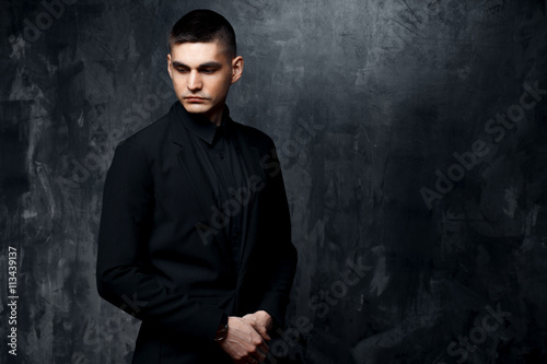 Portrait of handsome man in a black suit.