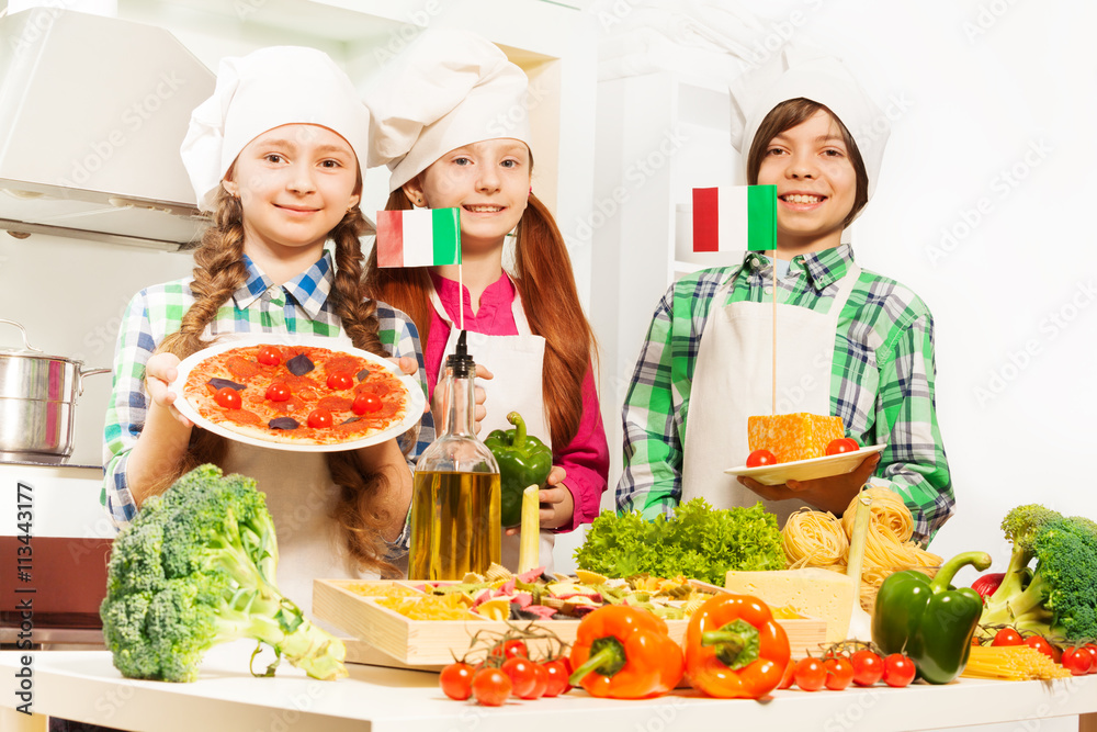 Three cooks with traditional Italian food products Three cooks with traditional Italian food products