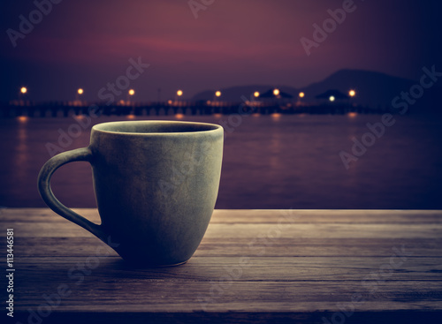 Coffee cup on wooden plank