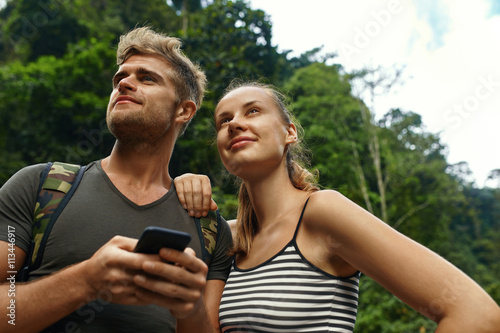 Travel And Tourism. Tourist People Adventure On Summer Vacation. Couple Of Beautiful Happy Cheerful Young Traveler Friends, Man And Woman Enjoying Nature Of Tropical Forest In Summer. Active Lifestyle
