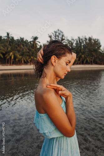 Young pretty girl standing on the sand during sunset  © mielemhoney