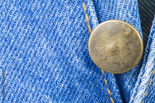 Part of blue jean with botton with copyspace macro background.