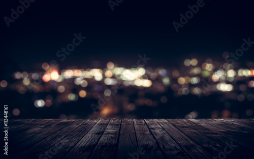 Wooden plank above the town at night