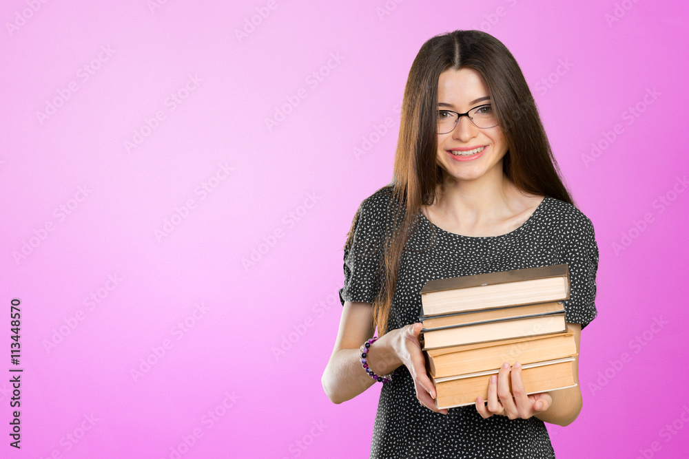 Smiling business woman holding stack of books Smiling business woman holding stack of books
