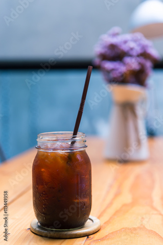 Iced Americano black coffee on a wooden table