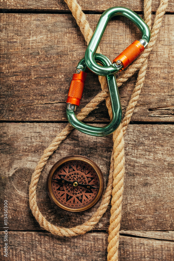 Fototapeta premium ship ropes and compass on wooden background