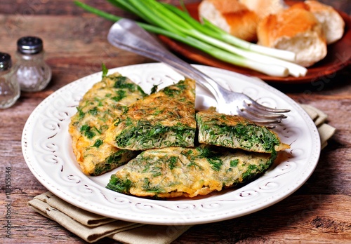 Scrambled eggs with parsley, dill, coriander and green onions. Breakfast.