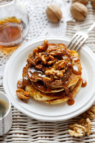 Pancakes with walnuts and caramel sauce, delicious dessert or breakfast
