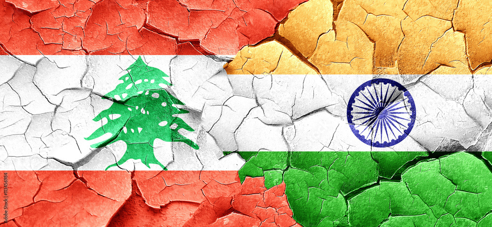 Lebanon flag with India flag on a grunge cracked wall