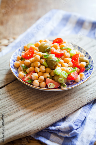 Mediterranean salad board - cherry tomatoes, green olives, chickpea.