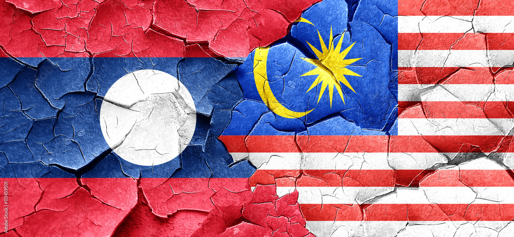 Laos flag with Malaysia flag on a grunge cracked wall