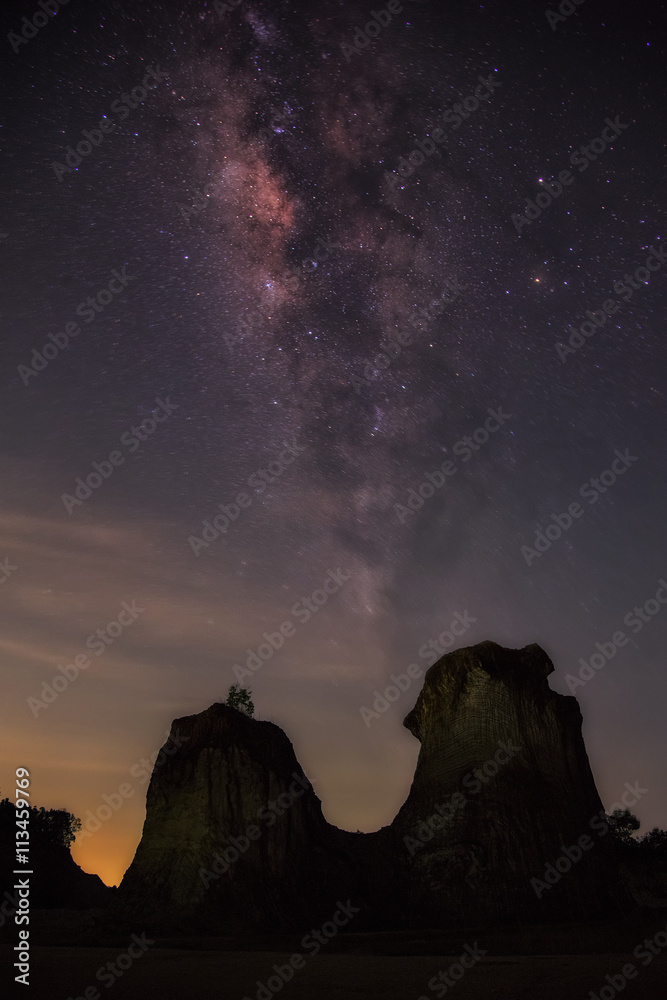 Landscape with Milky Way. Night sky with stars and silhouette of rock mountains.