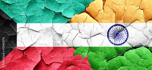 Kuwait flag with India flag on a grunge cracked wall