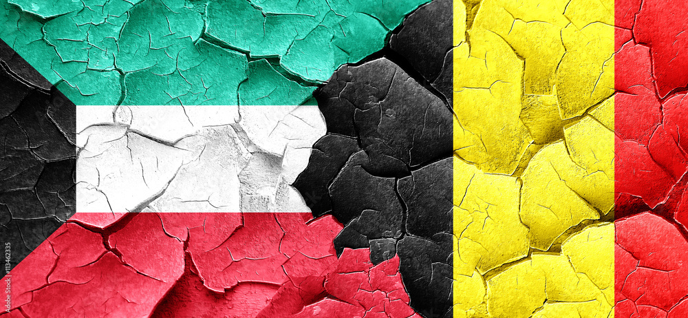 Kuwait flag with Belgium flag on a grunge cracked wall