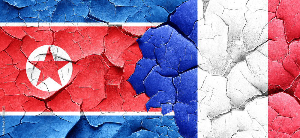 North Korea flag with France flag on a grunge cracked wall