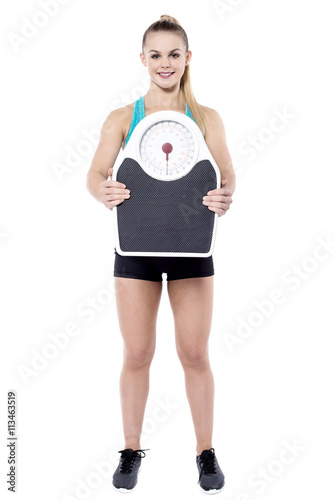 Young woman displaying her kilo or pound loss. © stockyimages