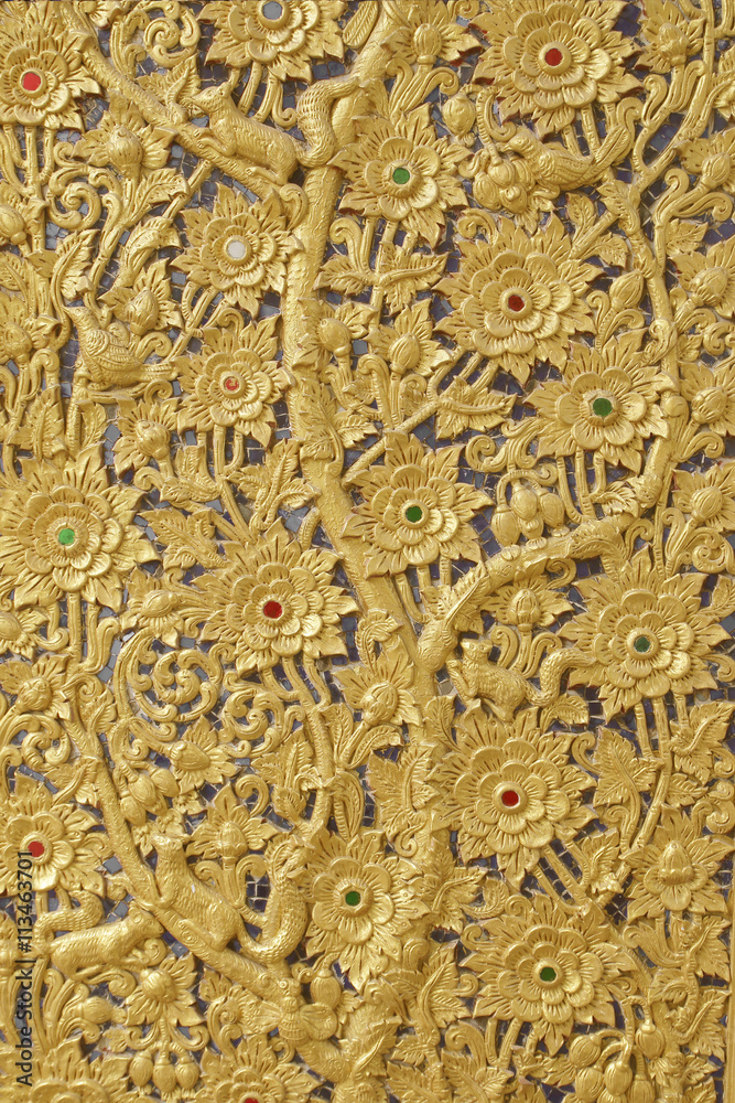 The gold stucco design of native thai style on the Wall