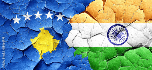 Kosovo flag with India flag on a grunge cracked wall