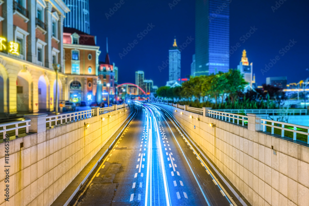 light trails with skysrapers background,tianjin china.