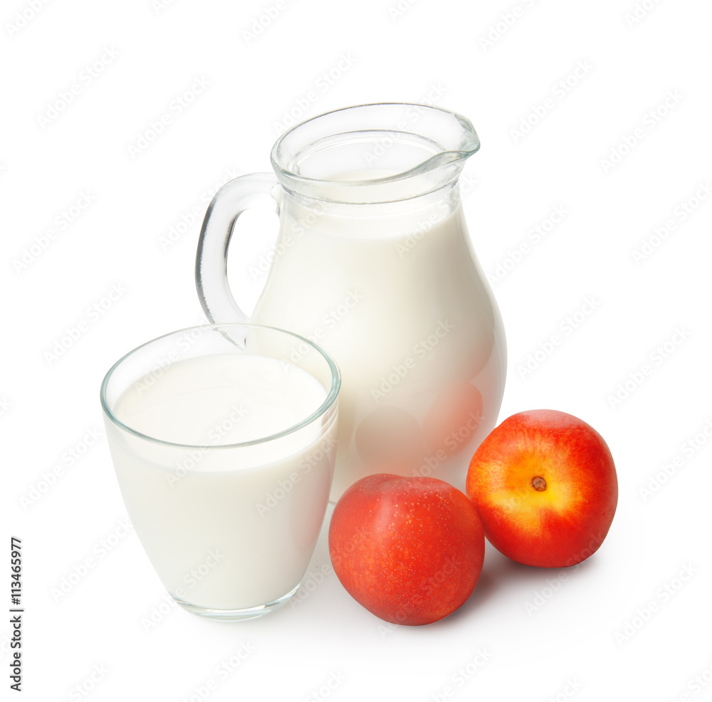 Glass of milk and jug with peaches on white Glass of milk and jug with peaches on white