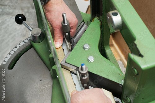 Craftsman working on frame in frameshop.