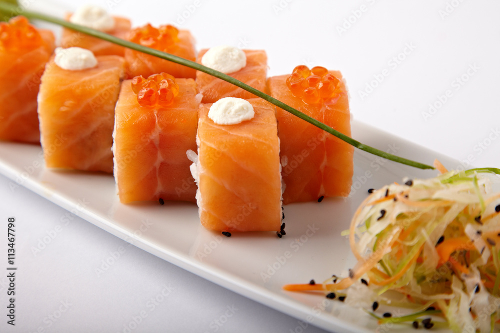 Plate of salmon sushi with lime and ginger on a white background Plate of salmon sushi with lime and ginger on a white background