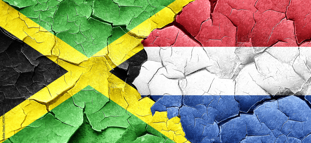 Jamaica flag with Netherlands flag on a grunge cracked wall