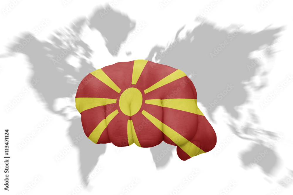 fist with the national flag of macedonia on a world map background