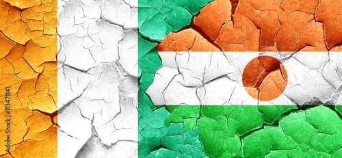 Ivory coast flag with Niger flag on a grunge cracked wall
