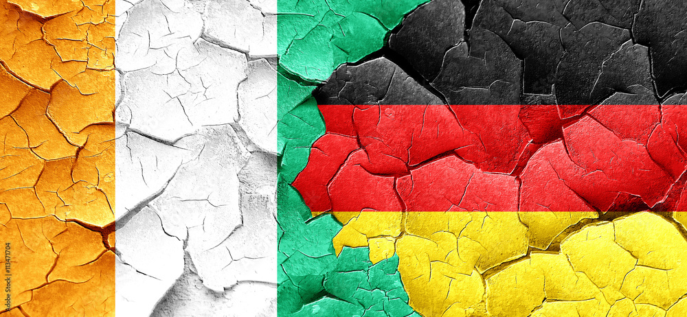 Ivory coast flag with Germany flag on a grunge cracked wall