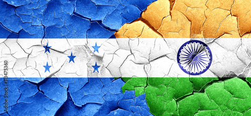 Honduras flag with India flag on a grunge cracked wall