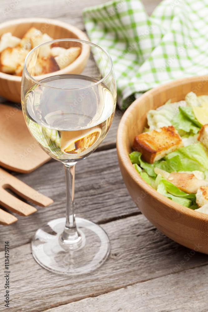 White wine glass and caesar salad White wine glass and caesar salad