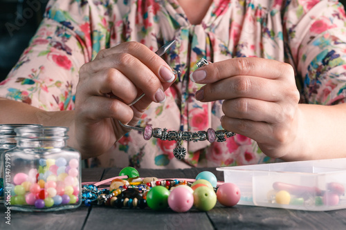 Relax hobby. Female make craft beads
