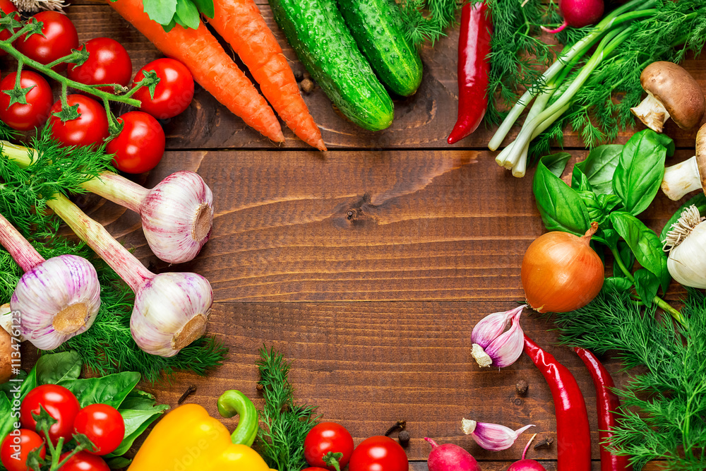 Beautiful background healthy organic eating. Studio photography the frame of different vegetables and mushrooms on the old brown boards with free space Beautiful background healthy organic eating. Studio photography the frame of different vegetables and mushrooms on the old brown boards with free space